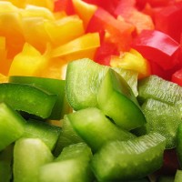 sliced and diced green, red, and yellow peppers